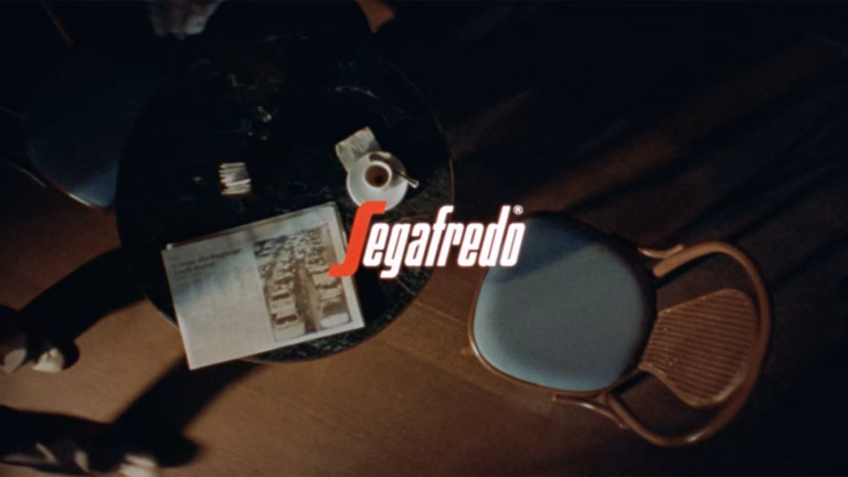 Segafredo Logo, Bartisch mit Kaffeetasse und Zeitung